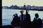 Merrymakers in carnival masks in boat on canal by James Doan