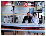 A Couple in back of the Model of the USS Enterprise CVN 65 by Courtesy of the Naval Air Station Fort Lauderdale Museum