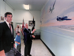 Jeb Bush and his son with Al McElhiney at the Mural the Final Approach by Courtesy of the Naval Air Station Fort Lauderdale Museum