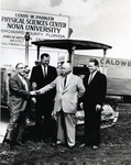 Signage in the photograph signals early construction of the Parker building in 1967. The Parker building was the second building to be constructed at the main campus site. President Warren Winstead (second from left in photograph, first President 1965-1969, of what was incorporated as Nova University of Advanced Technology in 1964), and Vice President C. I. Rice (fourth from left), look on as Louis Parker (first from left), shakes hands with George Caldwell Sr. (third from left)