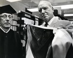 Louis W. Parker (on left), for whom the Parker building was dedicated, and an unidentified man prepare for a graduation ceremony where the former was granted an honorary Doctor of Science degree